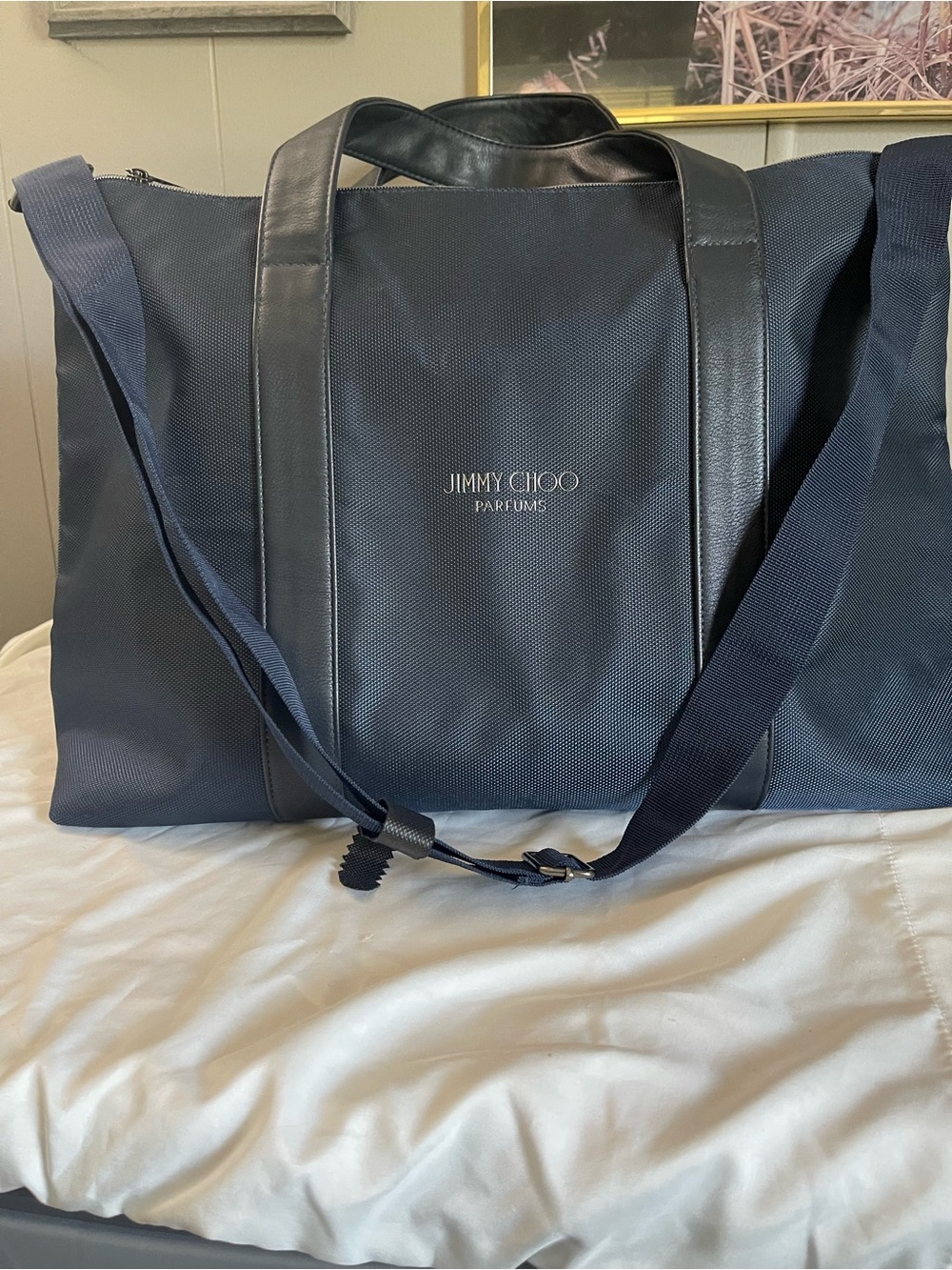 Large navy travel duffel from Jimmy Choo Parfums Durable fabric with leather